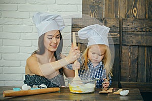 Mother and son mixing flour and eggs in bowl