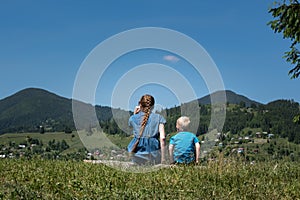 Mother and son on mountains background. Travel with small child