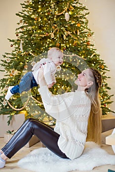 Mother and son near Christmas tree