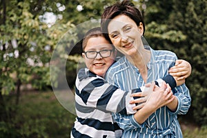 Mother and son outdoor lifestyle portrait in a park setting.