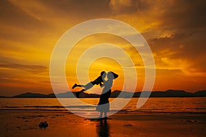 A mother and son in outdoors at sunset with copy space