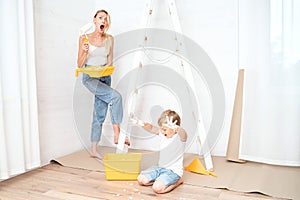 Mother with son painting the wall in home