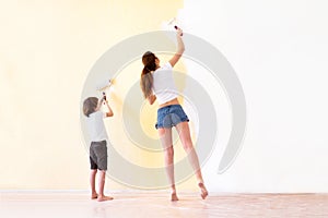 Mother and son paiting walls in a new house