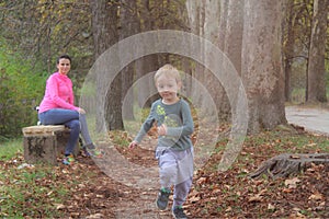 Mother and son in the Park and enjoying the beautiful autumn nature.Concept mum and son, childhood, happy life