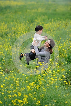 Mother and son play in flowers