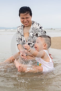 Mother and son playing on the beach