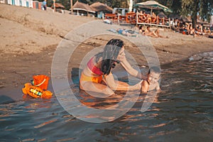 Mother and son playing on beach