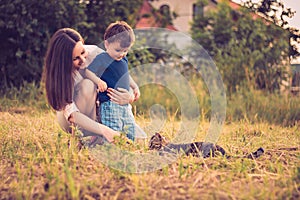 Mother and son playing with cat