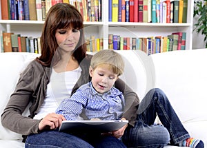 Mother and son playing with digital touchpad