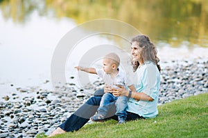 Mother and son playing near the lake