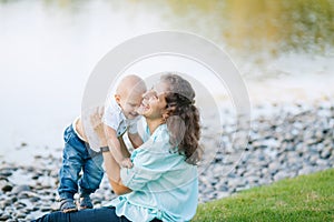 Mother and son playing near the lake