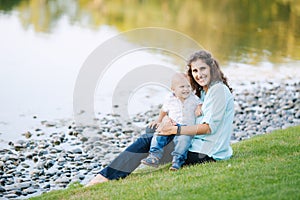 Mother and son playing near the lake