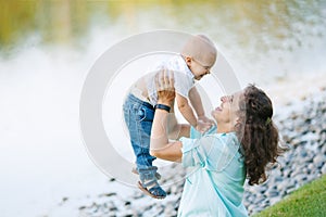 Mother and son playing near the lake