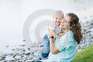 Mother and son playing near the lake