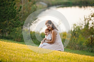 Mother and son playing near the lake