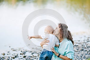 Mother and son playing near the lake