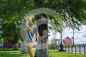 Mother and son playing in the Park near the tree on his hands