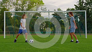 Mother, son playing soccer for fun outdoors in park. Happy family. Parents and children play football. Family on lawn