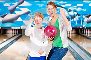 Mother and son playing together at bowling