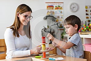 Mother and son Playing together with colorful didactic toys photo