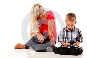 Mother and son playing video game on smart phone