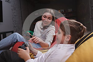 Mother and son playing video games together