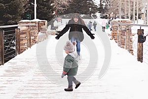 Mother and son playing in a winter park in Breckenridge, Colorado