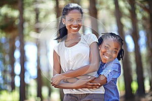 Mother and son quality time. Portrait of a mother and son embracing while enjoying a day outdoors.