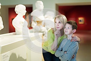 Mother and son regarding ancient statues