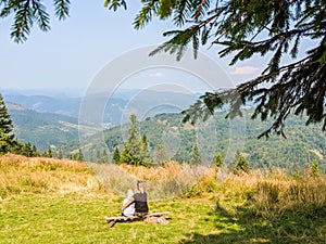 Mother with son relaxing on the carpathian mountains background
