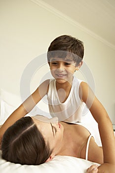 Mother And Son Relaxing On Bed