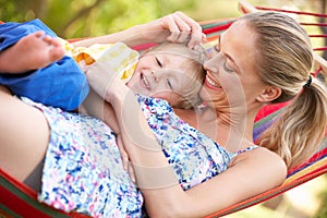 Mother And Son Relaxing In Hammock