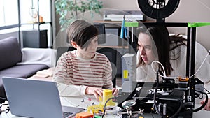 Mother And Son Researching 3D Printer Together