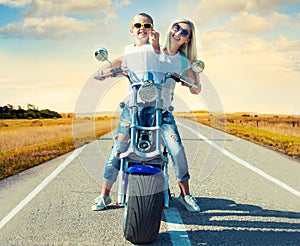 Mother and son rides on motorbike.