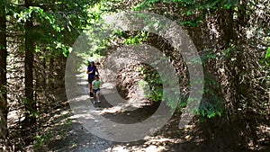 Mother and Son Running in the Forest