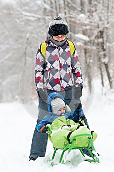 Mother and son on sledge