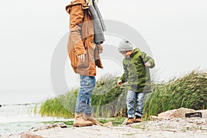 mother and son spending time on coast on foggy