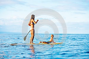 Mother and Son Stand Up Paddling Together