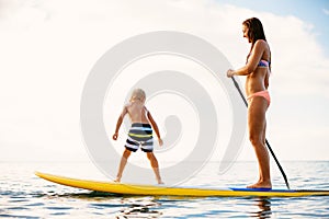 Mother and Son Stand Up Paddling Together