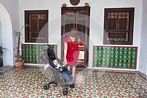 Mother and son standing at the house photo