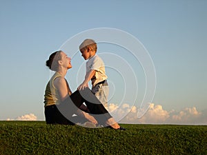 Mother with son on sundown photo