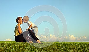 Mother with son on sundown