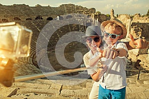 Mother with son take a vacation photo on the Side ampitheatre vi