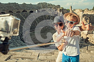 Mother with son take a vacation photo on the Side ampitheatre view. Traveling with kids concept image