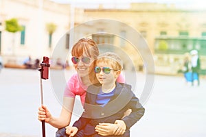 Mother and son taking selfie stick picture while