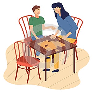 Mother and son together at home playing table logic game, connecting collecting puzzle pieces