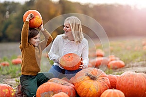 Mother and son in pumpkin patch field photo