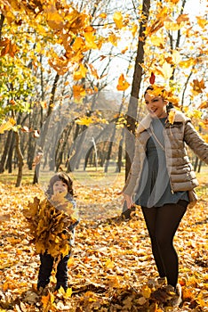 Mother and son tossing leaves