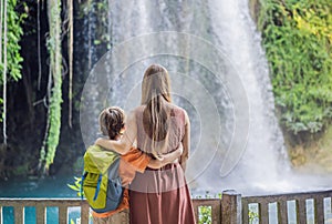 mother and son tourists on the background of Duden waterfall in Antalya. Famous places of Turkey. Apper Duden Falls