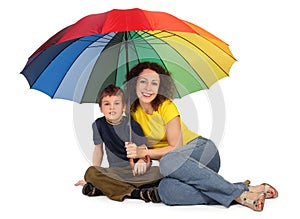 Mother and son with umbrella sitting isolated